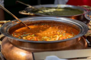 Close-up of a delicious curry with vegetables in a serving dish at a food stall