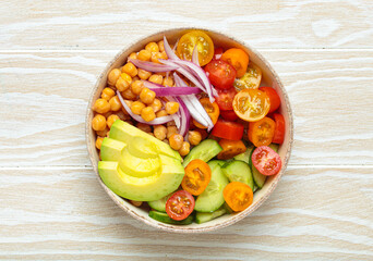 Healthy chickpea salad with ripe avocado, juicy cherry tomatoes, crisp cucumber, and red onion slices. Perfect for a nutritious and healthy meal