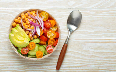 Healthy chickpea salad with ripe avocado, juicy cherry tomatoes, crisp cucumber, and red onion slices. Perfect for a nutritious and healthy meal