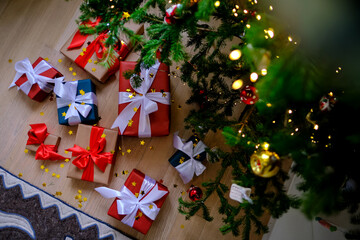 Lots of Christmas presents under the decorated Christmas tree.