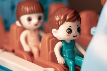 Toy airplane passengers on plastic seats. Toy man passenger in the airplane cabin