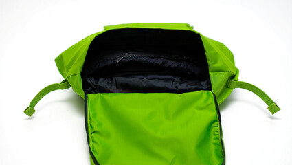 Bright green backpack interior with zippered compartment and straps