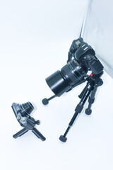 Camera setup in studio with tripod and small camera positioned for creative photography techniques