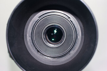 Close view of a camera lens showcasing its intricate details and reflection in natural light