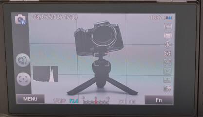 Camera setup on a tripod with display settings visible for perfect shot composition in a controlled environment