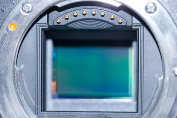 Close view of a camera sensor revealing intricate details and internal components in a controlled lighting environment