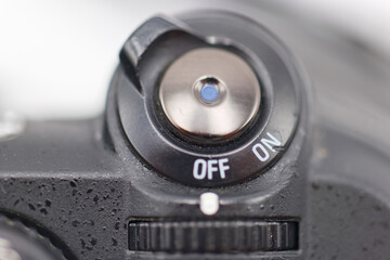 Camera power switch in close up showing off and on positions for photography equipment usage