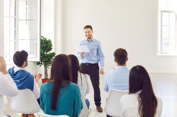 Fototapeta premium Male chief is leading a group meeting or conference for the team in the office. Effective business communication, teamwork, and training, essential for team productivity and cohesion.