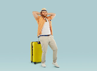Happy tourist, traveler man holiday excursionist with yellow wheel suitcase bag ready for summer trip dreaming of leisure, recreation, travelling, happy to enjoy sea rest, going to distant lands