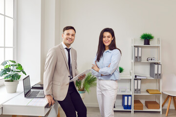 Happy colleagues meet in office room chatting enjoy friendly conversation, smiling business mates...