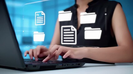 Woman typing on laptop with digital file management interface. Virtual folders and documents floating above computer screen in modern office environment with holographic data visualization technology.