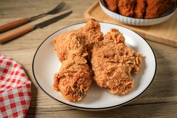 Fried chicken in  a white plate onwooden background