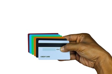 The right hand holds several dummy credit cards on a white background.