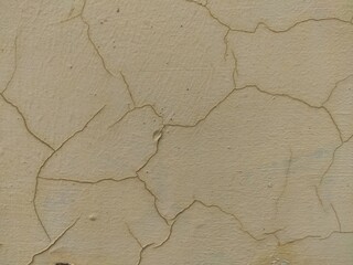 Beige cracked wall plaster texture for minimalist backgrounds and subtle architectural mapping