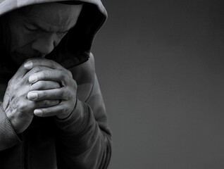 man praying to god with hands together Caribbean man praying with black background with people stock photo stock image