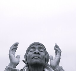 man praying to god with hands together Caribbean man praying with black background with people stock photo stock image