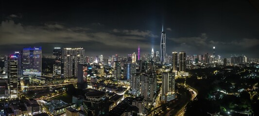 Nighttime view of a sprawling city skyline.