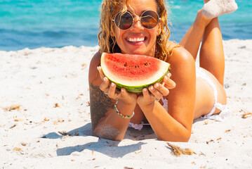 Beautiful curly-haired woman in her 40s enjoying a beach vacation with joyful expressions. Outdoor...
