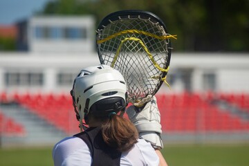 woman athlete in lacrosse uniform.