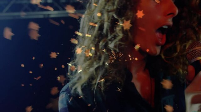 Singer gripping microphone and singing causing leaf particles swirling around revealing pianist