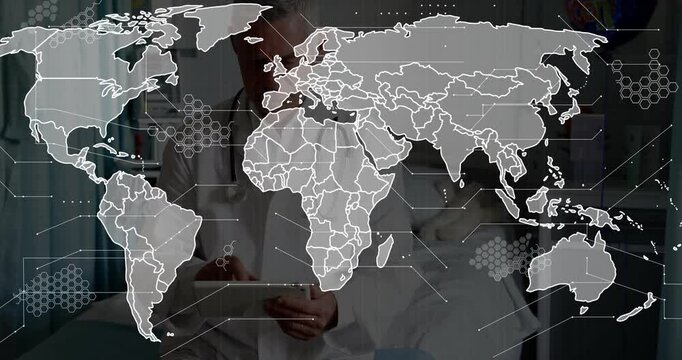 Senior male doctor tapping tablet beside bed showing global health map, borders and network nodes