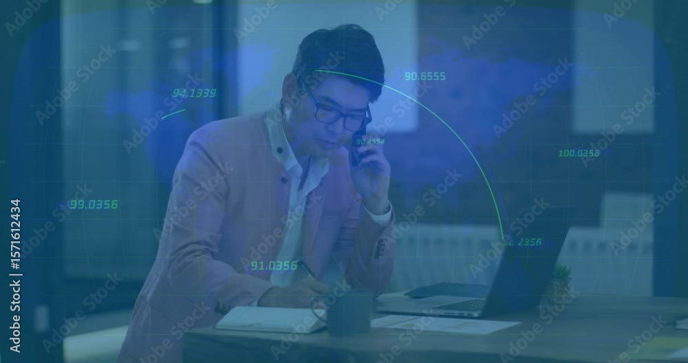Poster man lifting phone and jotting notes while on business call, subtle data lines appearing over laptop