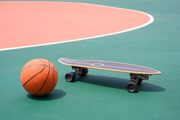 Basketball and skateboard on colorful outdoor basketball court