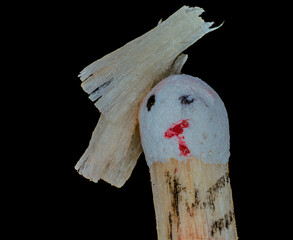 Creative matchstick character with drawn face and wooden hair