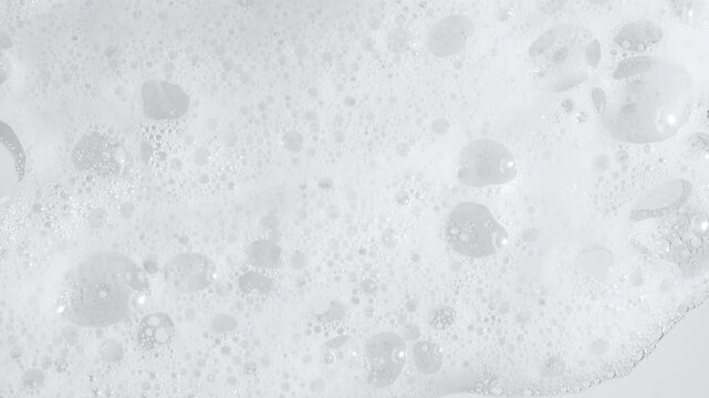 Texture of white soap foam with bubbles abstract background. Soap sud macro structure. Bathtup Soap Foam. Natural White Shampoo Bubbles Motion. High quality 4k footage
