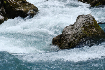 protruding stones in a turbulent mountain river close-up