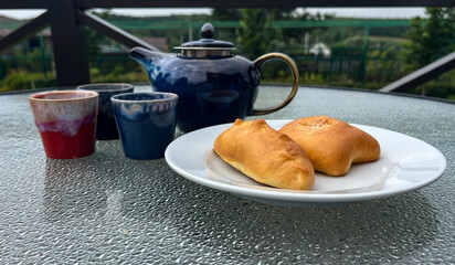 Breakfast on the terrace. A tea set and a plate of pies.