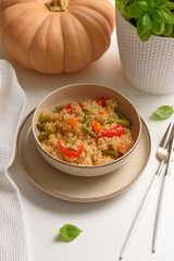 Quinoa vegetable salad on white wooden table. Vegetarian and diet food