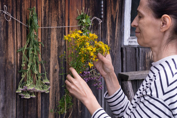  woman hanging herbs for drying