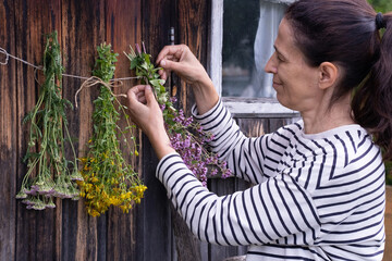  woman hanging herbs for drying