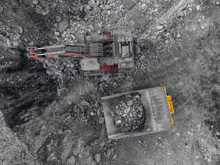 Aerial view of open pit coal mine excavation in winter with heavy machinery