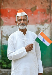 Indian Independence Day Greeting Advertisement With Elderly Indian Man Honoring Freedom with Flag