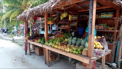 A vibrant fruit stand displaying a colorful array of tropical produce. - Powered by Adobe