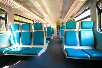 Interior of railway wagon with row comfortable blue seats