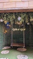 Swing with a 'wild at heart' neon sign in the background 