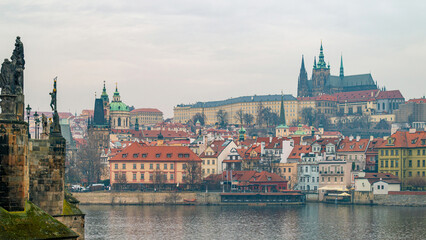 Prague, Czech Republic. Scenic view of Prague's iconic Charles Bridge with its historic arches and Baroque statues, overlooking the Vltava River and Lesser Town