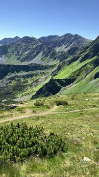 Brestova, Rohace, Western Tatras, Slovakia. Beautfiul landscape summer scenery of rocky alpine mountains. Peak, summit and top. Clear blue sky. Panoramatic panning vertical video.