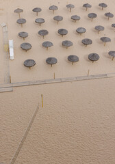 Tiki Beach Umbrellas and Volleyball Net on Sandy Beach