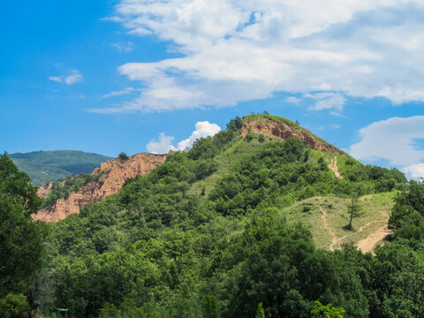 Stob Earth Pyramids in Bulgaria with natural sandstone formations and green vegetation. Geology, erosion, rock columns, landscape, outdoor, travel, natural landmark, Balkan, terrain, scenic view