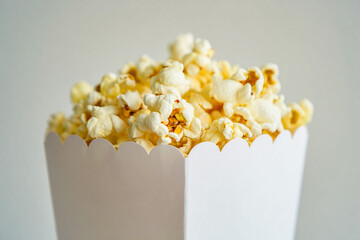 Stock photo of fresh delicious popcorn in a white box for movie night snack food photography image