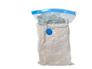 Vacuum sealed bag with clothes compressed for storage or travel isolated on transparent background