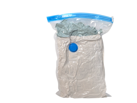 Vacuum sealed bag with clothes compressed for storage or travel isolated on transparent background