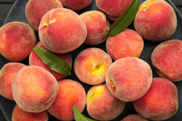 Ripe red peaches with green leaf. Macro photo