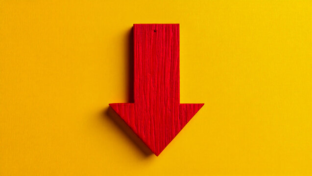 Red arrow pointing down stock photo on yellow background for business and design projects usage