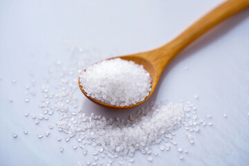 Sea salt on wooden spoon cooking ingredient culinary food photography close up macro shot white background