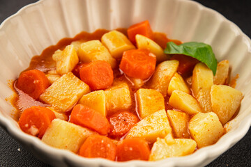 Stewed potatoes with carrots vegetarian side dish fresh delicious gourmet food background on the table rustic food top view copy space keto and paleo diet vegan food